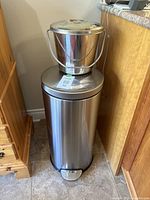 Trash can and compost pail together showing size and material