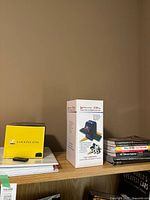 Nikon Coolpix B700 box and Wolverine converter box on shelf