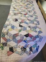 Full view of patchwork quilt spread out, showing pattern and size