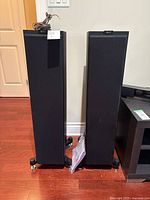 Front view of both KEF floorstanding speakers with grilles on