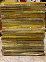 Full stack of National Geographic magazines showing quantity and yellow spines