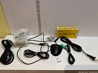 Full lot showing mouse, power cords, adapter, phone cord, boxed bulbs