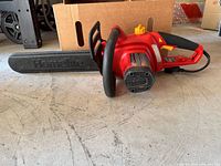 Full side view of red Homelite electric chainsaw with 16-inch bar