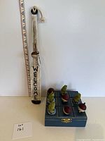 Full view of tic tac toe game and paddle sign