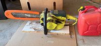 Full view of Pioneer chainsaw with gas can