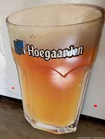 Front view of metal Hoegaarden pint glass sign