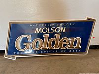 Front view of Molson Golden sign showing full text and colours