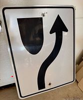 Front view of reflective median arrow sign showing graphic and condition