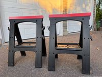 Both sawhorses standing upright on driveway showing overall structure and color