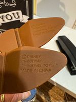 Molded boot soles showing Disney Thinkway Toys markings