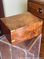 Closed burled walnut lap desk showing brass corner mounts and grain