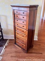 Front view of Wellington secretaire chest showing seven drawers and vertical locking pilaster