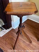 Full view of oak plant stand showing top, column and legs