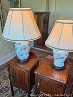 Both matching vase lamps on side tables showing height difference
