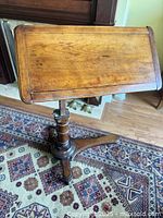Full view of mahogany adjustable reading table showing top and base