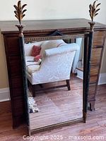 Front view of mirror leaning against dresser