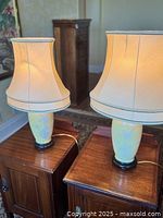 Pair of matching yellow porcelain table lamps on wood bases with fabric shades