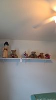 Shelf view showing kimono doll, four teddy bears, kokeshi
