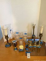 Full group of brass and glass décor on table showing overall quantity and variety