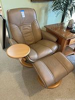 Front view of recliner with ottoman and side tray