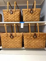 Four wicker picnic baskets on two shelves; shows size grouping and overall style