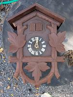 Front view of cuckoo clock housing showing overall design and missing parts