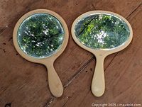 Both hand mirrors front view showing shape and handles