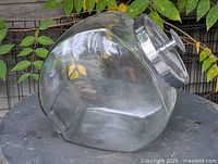 Full view of glass candy jar on side showing shape and lid