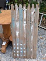 Front view of six-board picket fence wall hanging showing stars and distressed paint