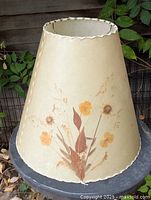 Full view of conical paper lampshade with pressed flower design