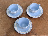 Three cups and saucers arranged on table