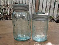 Both Crown embossed jars side by side showing lids and embossing