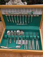 Open chest showing full assortment of flatware pieces