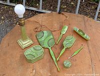 All eight matching light green Art Deco pieces displayed on table