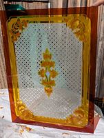 Front view of entire ruby and frosted glass panel showing border, lattice centre, corner and central floral motifs