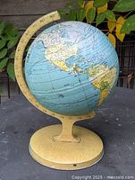 Full view of globe on stand