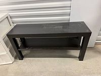 Full frontal view of black MDF console table