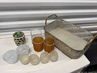 Group overview: metal tray and assorted glass votives/vase