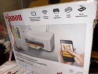 Retail box front showing Canon branding, printer image and wireless features