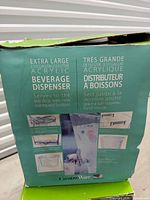 Box front showing CreativeWare acrylic beverage dispenser, capacity and features