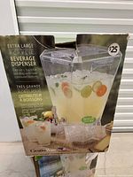 Front of retail box showing full image of the dispenser and capacity info