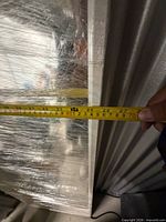 Tape measure across mirror width showing approx 25 in