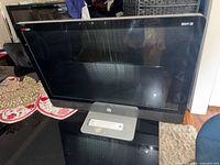 Front view of HP Envy 23 all-in-one showing screen and stand