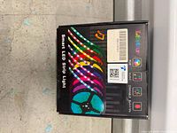 Front of retail box showing L8star branding, Smart LED Strip Light label, RGB, Music, Dimmable icons