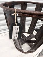 Side view showing slatted construction and rusted finish