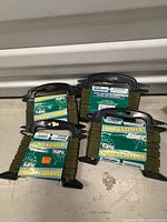 Four sealed retail packages of Famous 3 mm olive green utility cord displayed flat