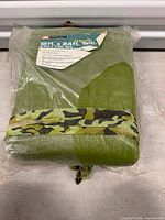 Front view of sealed Ozark Trail tarp package showing size label 12 ft x 24 ft