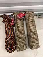 Three coiled ropes on floor: two camo, one black/red/yellow tracer