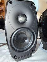 Front view of one Paradigm speaker showing drivers and Paradigm logo