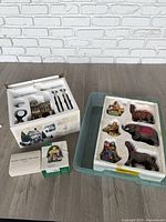 Overall view of all Department 56 items including gift set, nativity figures tray, Iron Fence box and star accessory box